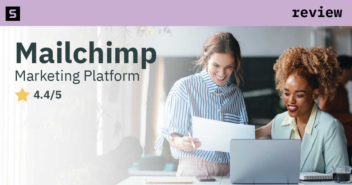 Smiling businessman next to 4 stars and pointing at Mailchimp logo.