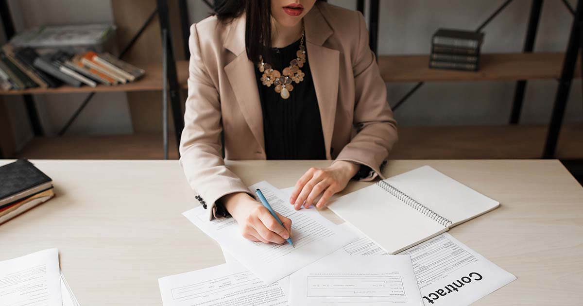 Businesswoman signing contracts.