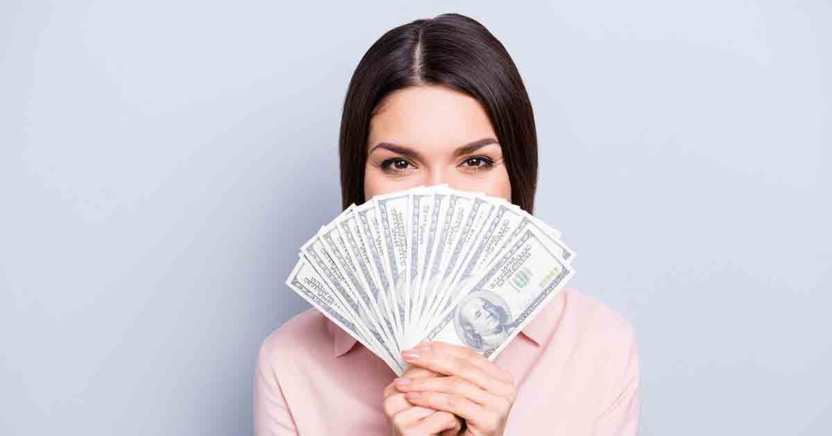 Woman holding money.