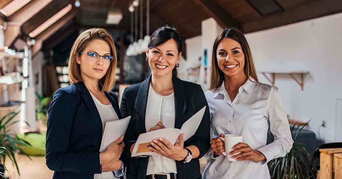 Three smiling businesswomen.